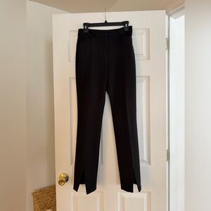 Black high-waisted pleated straight leg trousers with front slit